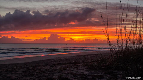 a colorful cloudscape and sunrise at the beach