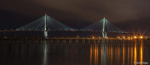 panoramic view of an illuminated bridge by night