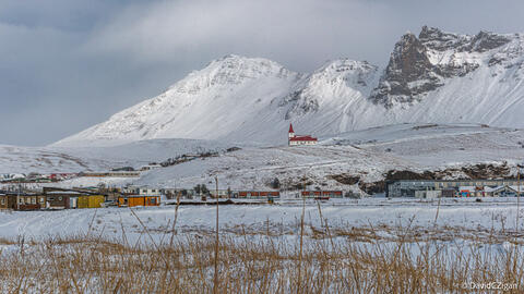 winter landscape of a town with snow-covered mountains