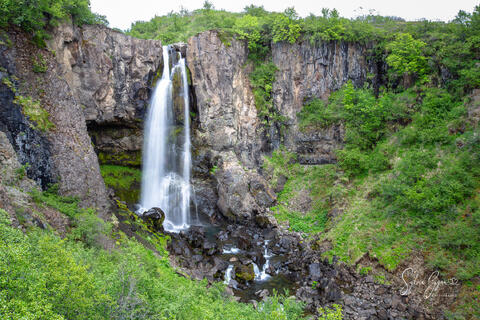 silky long-exposure waterfall on a rocky cliff
