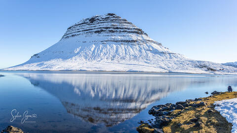 reflection of a snow covered mountain