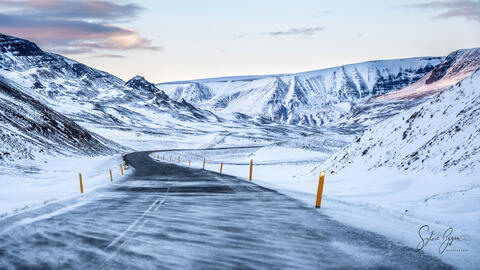 snow and ice on a road in mountains