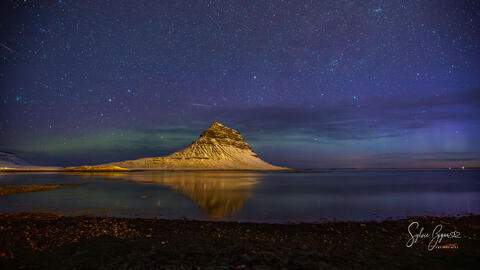 aurora over a snow covered mountain