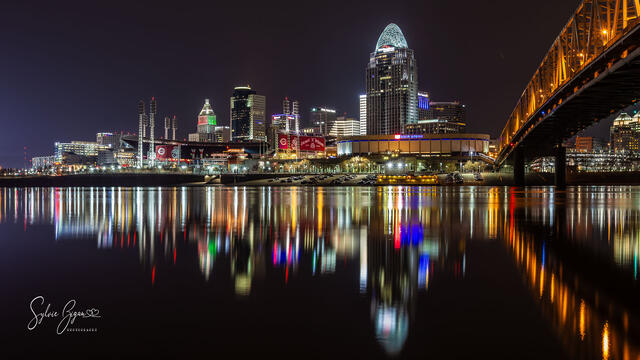 colorful cityscape light reflected in calm water at night