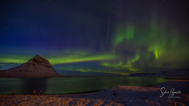 Aurora Borealis display over landscape